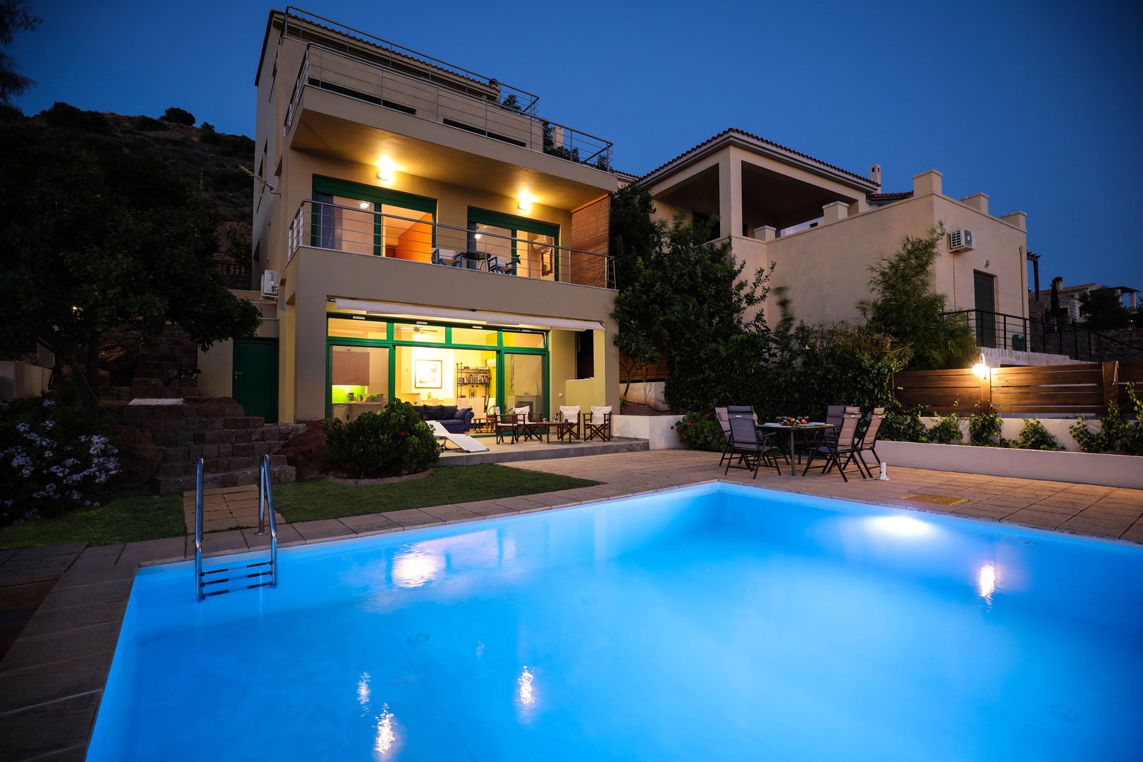 Front view of Eucalyptus Properties and infinity swimming pool at night.