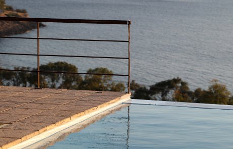 Pool corner Corner of an infinity swimming pool with view at dusk